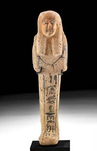 Egyptian New Kingdom Terracotta Ushabti Hieroglyphics: Egypt, New Kingdom, 19th Dynasty, ca. 1220 to 1100 BCE. A remarkable example of a mold-formed pottery ushabti enveloped in a rich hue of sienna with black-painted hieroglyphics inscribed vertically do