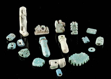 18 Egyptian Glazed Faience Amulets / Beads: Ancient Egypt, Third Intermediate to Late Dynastic Period, 21st to 31st Dynasty, ca. 1070 to 332 BCE. A wonderful selection of faience beads covered in layers of blue and blue-green glaze. First is a