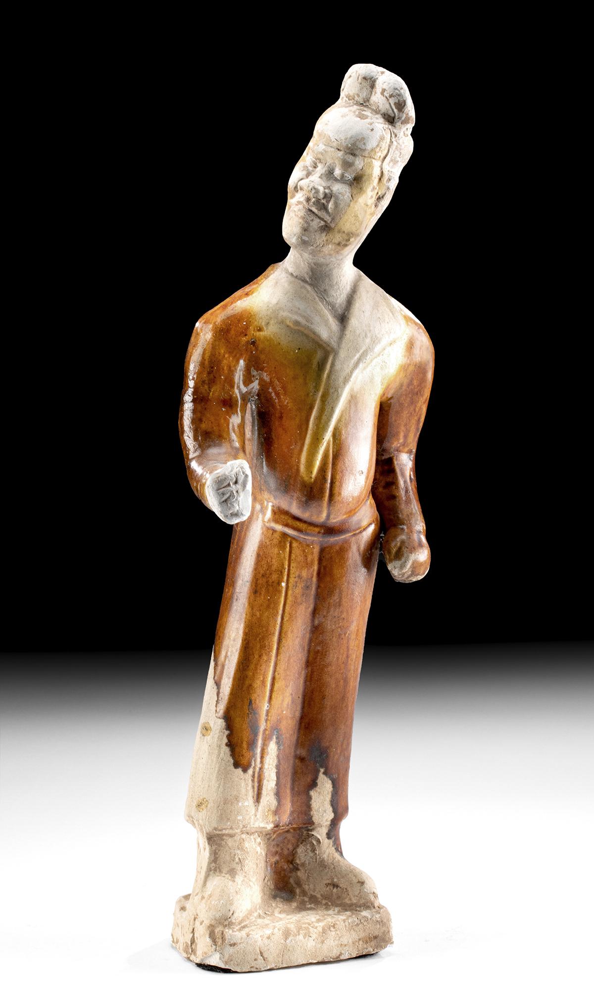Chinese Tang Pottery Foreign Groom w/ Sancai Glaze & TL: East Asia, China, Tang Dynasty, ca. 618 to 906 CE. A handsome mold-made pottery male figure standing atop an integral plinth. Holding his right fist out before him as though holding the reigns of a ho