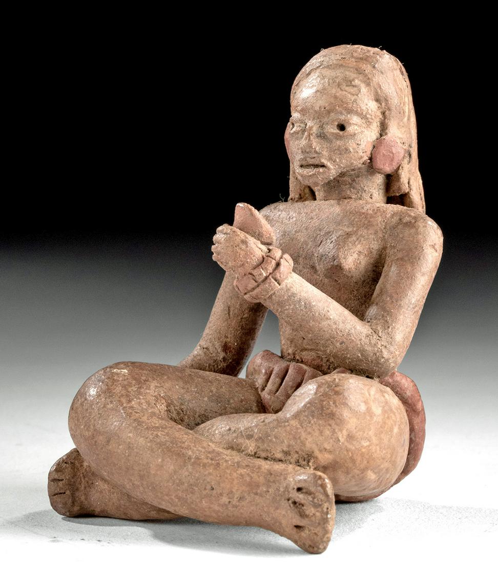 Guerrero Xalitla Pottery Seated Female Venus Figure: Pre-Columbian, Mexico, Guerrero region, Xalitla culture, ca. 1200 to 900 BCE. A hand-built pottery female Venus figure seated with crossed legs and wearing a simple waistband and loincloth. Her nude u