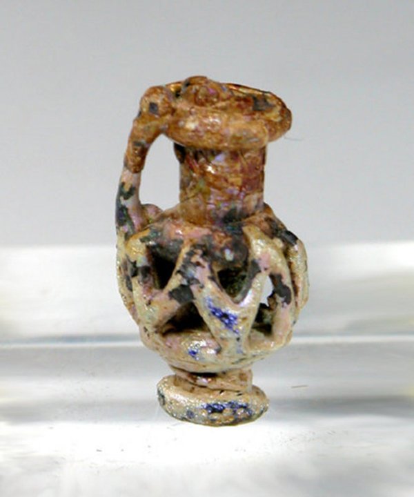Miniature Roman Glass Amphora: Ancient Miniature Roman Glass Amphora, ca. 3rd-6th century A.D. Single-handled vessel in miniature form with zigzag trailing around body; usually rendered in blue glass and, unlike most glass of the p