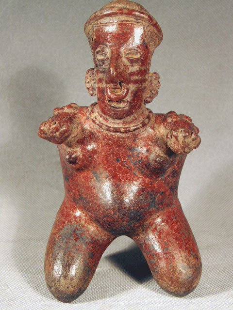 Pre-Columbian Jalisco Kneeling / Birthing Woman: Ca. 200 BC - 200 AD. Ancient Pre-Columbian Birthing Figure from Mexico, Jalisco. This figure shows a woman in the birthing pose, large stomach and arms out stretched. She wears detailed necklace, ear 