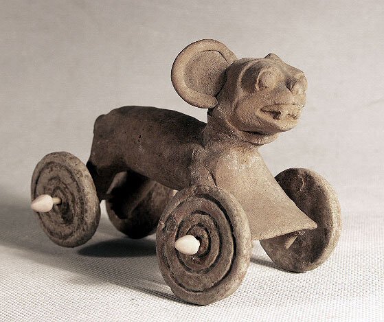 Pre-Columbian Vera Cruz Jaguar Childs Toy: Ca. 650 - 850 AD A very rare Veracruz pull toy of a jaguar. This piece shows a detailed face and body of a jaguar and has four of the original wheels that were used to pull the piece. The axles (stick
