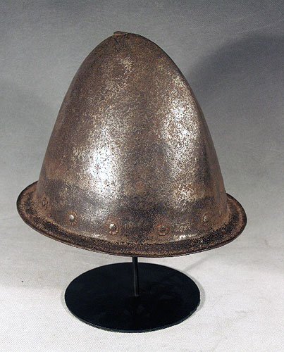 Spanish Conquistador Armor Helmet: Ca. 1550 - 1650 AD. An armor helmet likely Italian made but worn by the Spanish, as it was found in North America. Rosettes surround the helmet that hold the still intact headband inside. Great patina