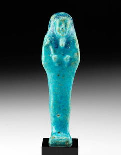 Egyptian Glazed Faience Ushabti w/ Blue Hues: Ancient Egypt, Third Intermediate Period, 21st to 25th Dynasty, ca. 1070 to 664 BCE. A sumptuous example of a mold-formed faience ushabti standing in mummiform atop an integral plinth. The slender