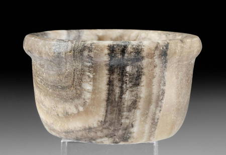 Egyptian Banded Alabaster Dish with Lipped Rim: Ancient Egypt, Pre-Dynastic to Old Kingdom Period, ca. 3500 to 2181 BCE. A wonderful alabaster dish displaying a circular, flat base and thick walls that rise to a lipped rim. Skillfully hand-carved,