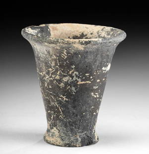 Egyptian New Kingdom Pottery & Painted Gesso Votive Cup: Ancient Egypt, New Kingdom, 18th to 20th Dynasty, ca. 1550 to 1070 BCE. A petite offering cup made from highly-burnished blackware pottery that bears a layer of creamy white gesso with faint remains
