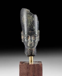 Egyptian Stone Head of a Pharaoh: Egypt, Late Dynastic Period, 26th to 31st Dynasty, ca. 664 to 332 BCE. A beautiful head of an unidentified pharaoh carved from mottled green-black hardstone with inclusions in hues sage green.