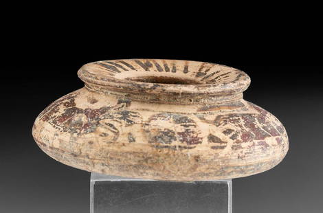 Squat Greek Corinthian Polychrome Jarlet: Greece, Corinthian, ca. 6th century BCE. A petite terracotta jarlet with a polychrome motif painted on the base, body, and rim of the vessel. The wheel thrown vessel rests on a rounded, but stable