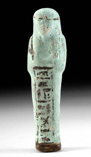 Egyptian Glazed Faience Ushabti w/ Hieroglyphs: Ancient Egypt, Third Intermediate Period, 21st to 25th Dynasty, ca. 1070 to 664 BCE. A lovely faience ushabti standing in mummiform and covered in a powdery, pale-blue pigment. The figure crosses