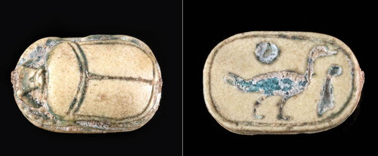 Petite Egyptian Glazed Faience Scarab Amulet w/ Duck: Ancient Egypt, Third Intermediate to Late Dynastic Period, 21st to 31st Dynasty, ca. 1070 to 332 BCE. A diminutive scarab amulet that is mold-formed from creamy honey-yellow faience bearing remains