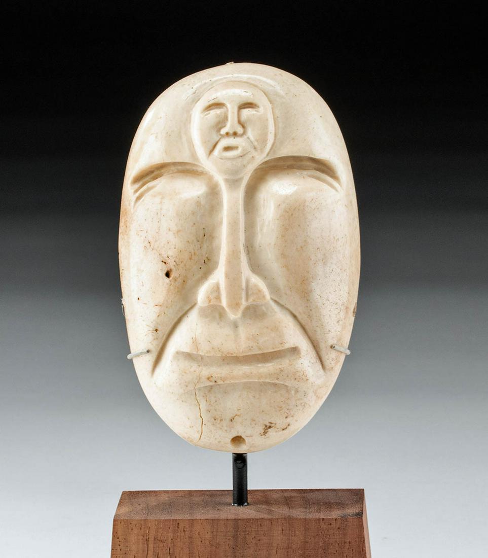 20th C. Alaskan Inuit Bone Spirit Effigy Mask: Native American, Pacific Northwest Coast, Alaska, Native Alaskan, mid 20th century CE. An intriguing spirit mask, hand-carved from possibly whale bone, depicting a squinting face with an entirely sepa