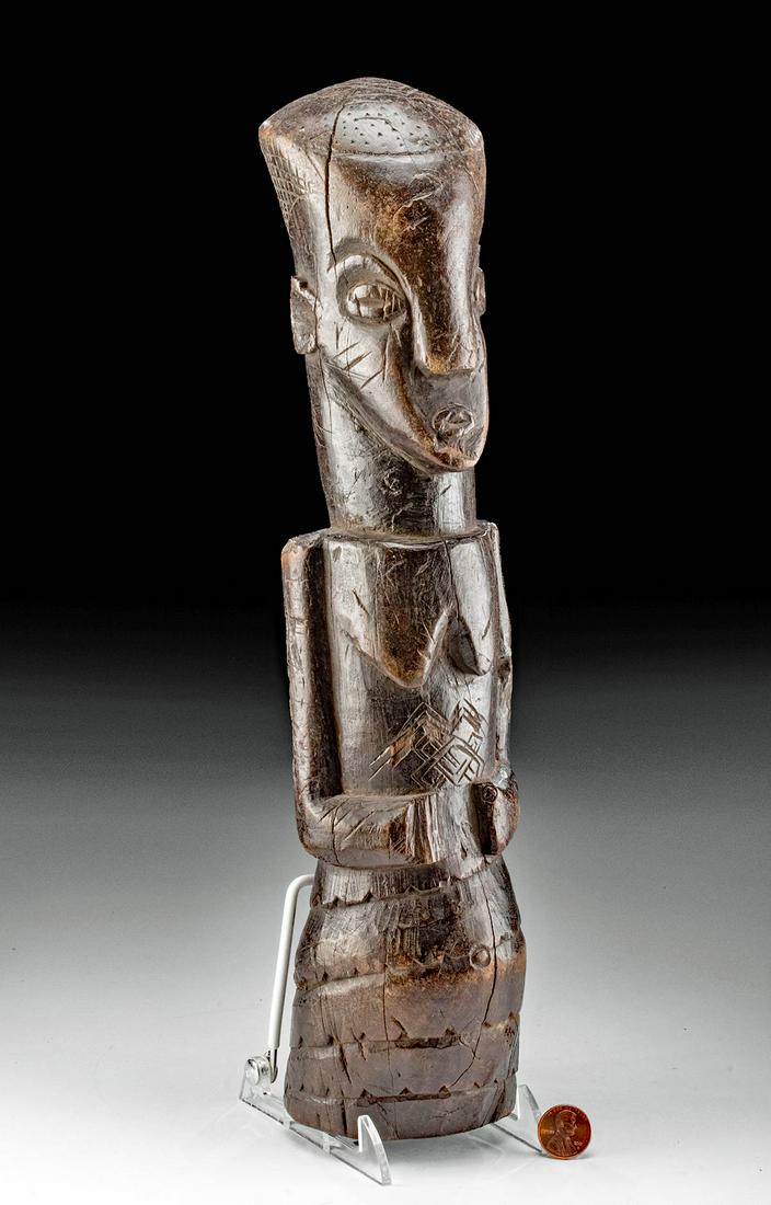 Late 19th C. African Kuba Wood Female Shrine Figure: Central Africa, Democratic Republic of the Congo, Kuba peoples, ca. early 19th to late 20th century CE. A lovely female shrine figure that is hand-carved from hardwood and presents with a stylized cyl