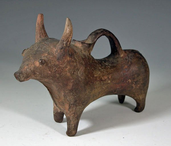 An Iranian Pottery Bull Askos: Early and fine ancient pottery bull, ca. 800 to 1000 B.C., from Iran. Brown burnished surface, bull stands with head alert, large horns extending vertically from top of head, small spout just forward 