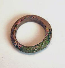 A Roman Glass Finger Ring: Ca 1st century AD. The exterior of the plain circular band of rounded form with excellent iridescence in some areas. Dimensions: US Ring size: 7 3/4 PROVENANCE: Paul Ilton private collection, acquired