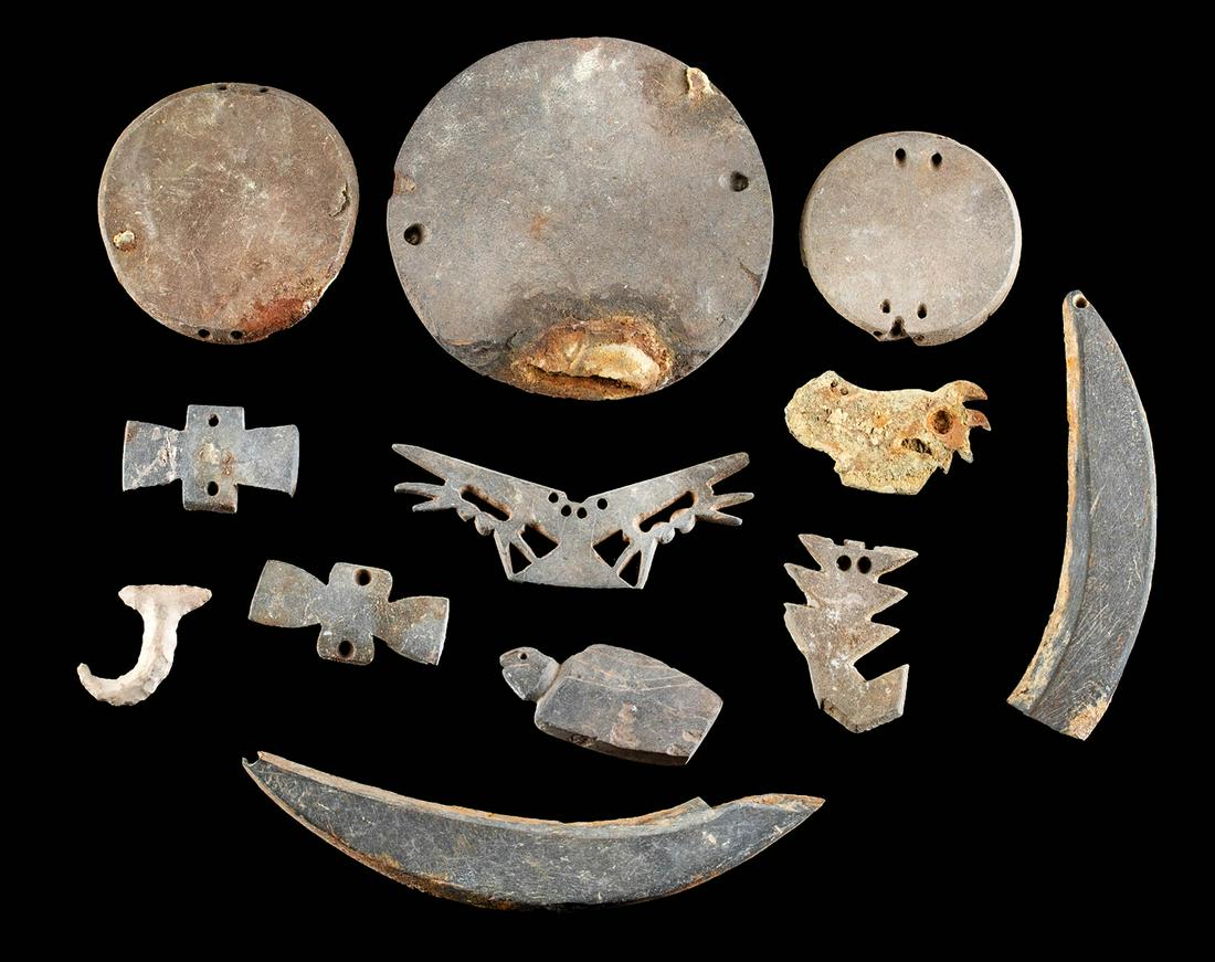 12 Native American Hopewell Woodland Stone Ornaments: Native American, Midwestern United States, Hopewell, ca. 100 to 1500 CE. A collection of 12 hand pecked and polished stone gorgets and tools from the mound building cultures of midwestern Native Ameri