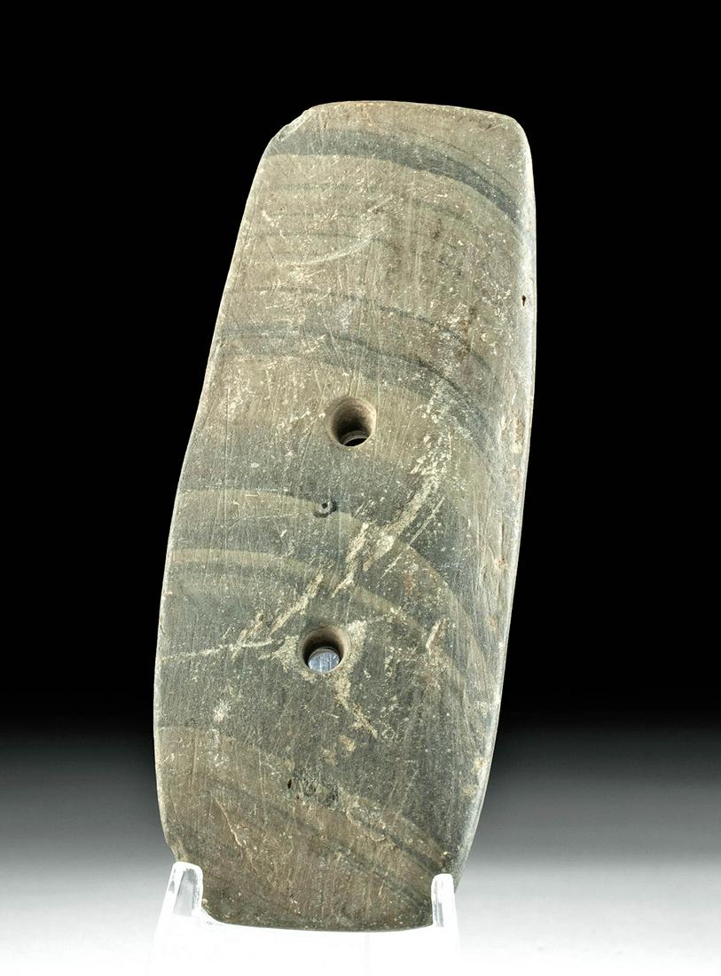 Native American Eastern Woodland Stone Gorget: North America, Native American, Eastern Woodland, ca. 100 to 1000 CE. A flat thin stone, hand-carved and hand-drilled with two holes through the center to use as a gorget. These stone gorgets were pos