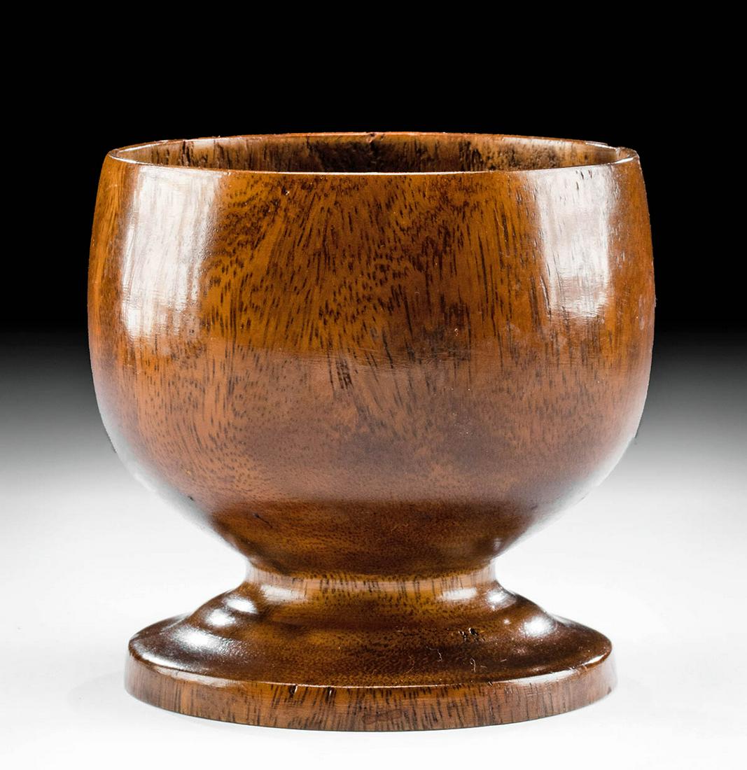 19th C. Hawaiian Hardwood Goblet: North Pacific, Hawaiian Islands, ca. 19th to early 20th century CE. An attractive goblet of a squat form that is lathe-turned from caramel-hued hardwood with mocha and espresso veining. The vessel exh