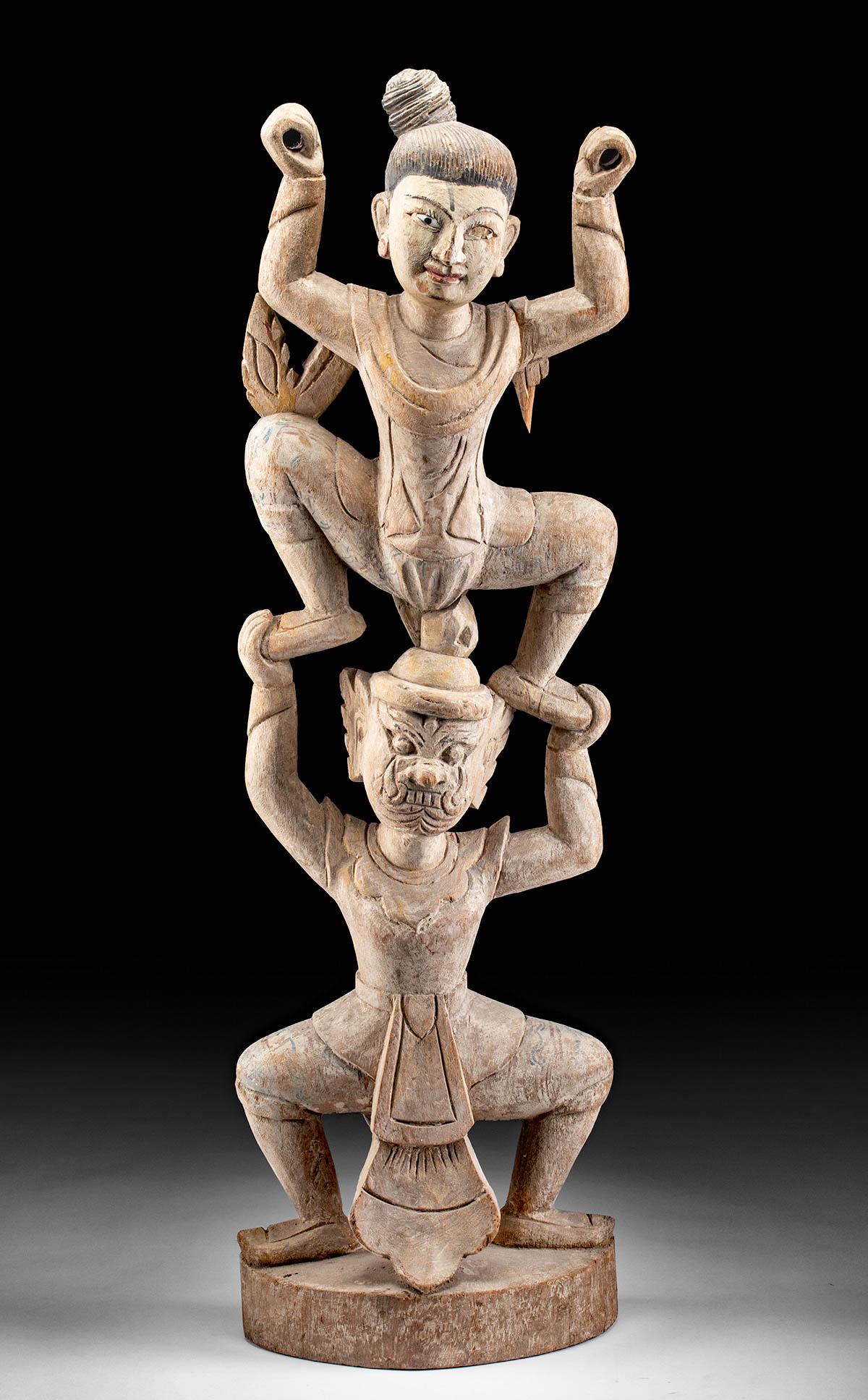 19th C. Thai Wood Dancing Figures w/ Tosakanth: Southeast Asia, Thailand, 19th to early 20th century CE. A large, hand carved wooden statue of two dancing figures. The lower is wearing a Khon face mask, depicting the demon Tosakanth. Tosakanth stan