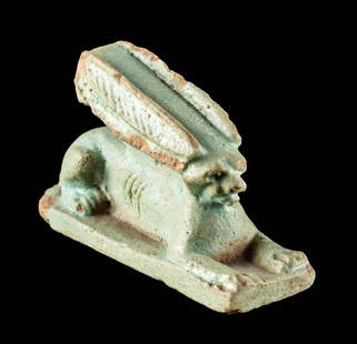 Egyptian Ptolemaic Faience Couchant Desert Hare Pendant: Egypt, Ptolemaic Period, ca. 332 to 30 BCE. A mold-formed pendant of a desert hare covered in pale blue-green glaze. The hare lays couchant atop an integral plinth with its forelegs extended in front