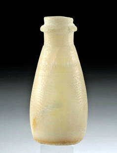 Egyptian Old Kingdom Banded Alabaster Alabastron: Ancient Egypt, Late Ptolemaic to Early Roman Period, ca. 150 BCE to 100 CE. A lovely alabastron, hand-sculpted from banded alabaster ranging from a creamy beige to a buttery pale yellow, that glows