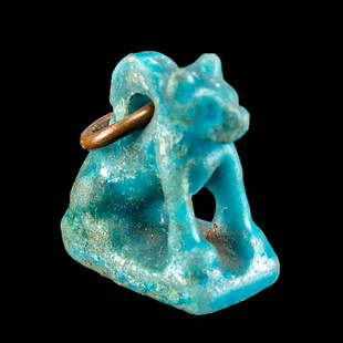 Miniature Egyptian Glazed Faience Seated Cat Pendant: Ancient Egypt, Third Intermediate Period, 21st to 25th Dynasty, ca. 1070 to 664 BCE. An adorable faience cat pendant of a miniature size that is enrobed in lustrous sky-blue glaze. The minute feline