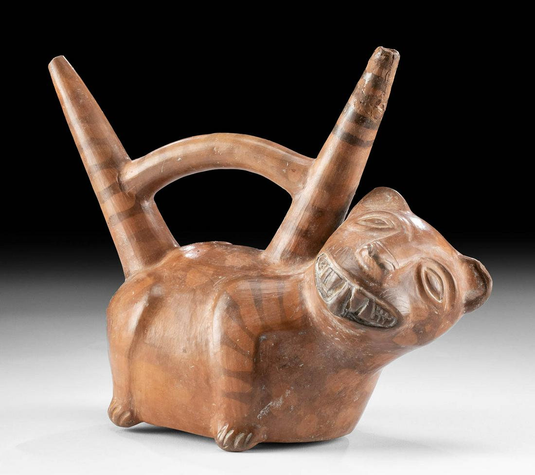Fine Vicus Bichrome Double Spouted Vessel - Jaguar Form: Pre-Columbian, North Coast Peru, Vicus ca. 400 to 100 BCE. A dramatic pottery vessel in the form of a standing jaguar with a spotted coat and striped limbs. The ancient beast presents a plump body as 
