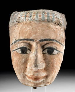 Egyptian Polychrome / Gesso Wood Mummy Mask: Egypt, Late Dynastic Period, 26th to 31st Dynasty, ca. 664 to 332 BCE. A stunning wood mummy mask that is expertly carved from cedar and covered in a layer of white gesso painted in hues of beige, pea