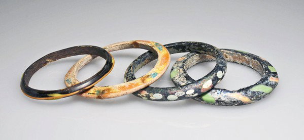 A Group of 4 Near Eastern Bracelets: Roman period, ca. 1st-2nd Century A.D. Multi colored glass bracelets. 3- 5/8" (9.2cm). Provenance: ex. Moro collection of Ancient Glass, 1960s-2003. Said to be found in Syria. no reserve