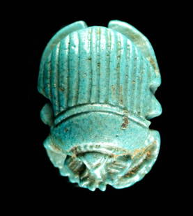 Egyptian Glazed Faience Scarab Button Pendant: Egypt, Late Dynastic (27th Dynasty) to Ptolemaic Period, ca. 525 to 30 BCE. A mold-formed faience scarab button pendant of naturalistic ovoid form, all covered in layers of lustrous light-blue glaze.