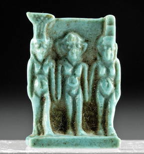 Egyptian Glazed Faience Amulet - Triad of Alexandria: Egypt, Alexandria, Late Dynastic to Ptolemaic Period, ca. 664 to 30 BCE. A fabulous mold-formed faience amulet covered in attractive turquoise-hued glaze. The amulet depicts the triad of Harpokrates