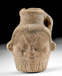 Romano-Egyptian Pottery Jar - Head of Bes: Egypt, probably Alexandria, Romano-Egyptian Period, ca. 30 BCE to 2nd century CE. A fine brownware pottery molded juglet depicting the head of Bes, a dwarf protector deity, with a small strap handle