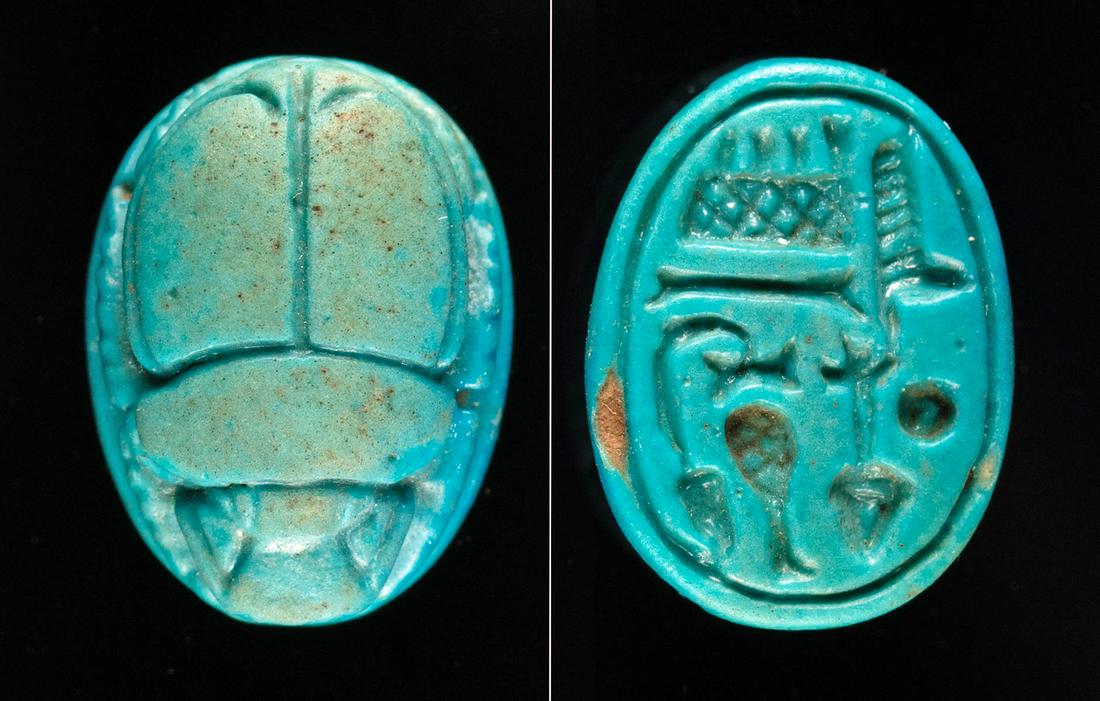 Egyptian Glazed Faience Scarab Pendant w/ Inscription: Ancient Egypt, New Kingdom, 18th Dynasty, ca. 1550 to 1292 BCE. A finely preserved, mold-formed faience scarab pendant of ovoid form covered in layers of matte blue glaze. The topside bears finely det