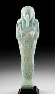 Translated Egyptian 30th Dynasty Faience Ushabti: Egypt, Late Dynastic Period, 30th Dynasty, ca. 380 to 343 BCE. A fantastic mold-formed faience ushabti covered in soft turquoise-hued glaze. The figure stands in mummiform with fused legs and a