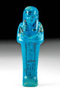 Gorgeous Egyptian Glazed Faience Ushabti for An-mose: Ancient Egypt, Third Intermediate Period, 21st Dynasty, ca. 1070 to 943 BCE. A breathtaking example of a hand-built faience ushabti, standing in a dignified pose, that is enrobed in layers of