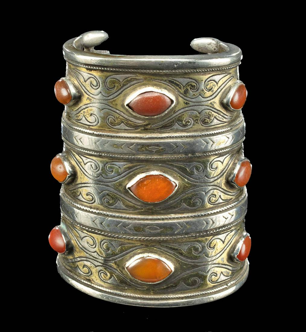 19th C. Turkoman Gilt Silver Carnelian & Glass Bracelet: Central Asia, Turkmenistan and Afghanistan, Turkoman (Turkman) Tekke peoples, ca. 19th century CE. A striking gilt silver bracelet consisting of 3 horizontal registers adorned with 8 carnelian and 1 g