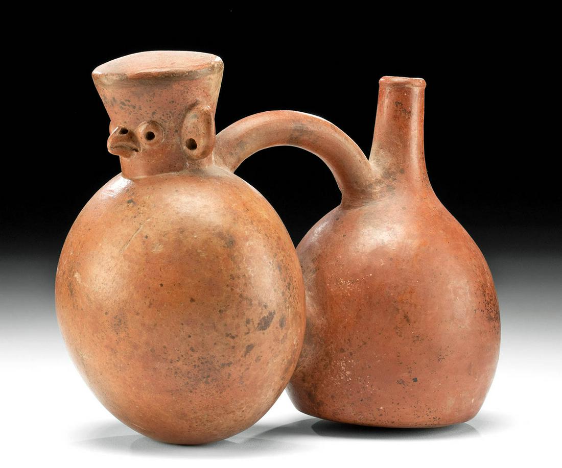 Viru Redware Double Chamber Vessel, ex-Museum: Pre-Columbian, northwest coast Peru, Viru culture, ca. 100 BCE to 600 CE. A remarkable redware vessel comprised of 2 bulbous chambers that are connected via a brief tunnel at their side and a tubular