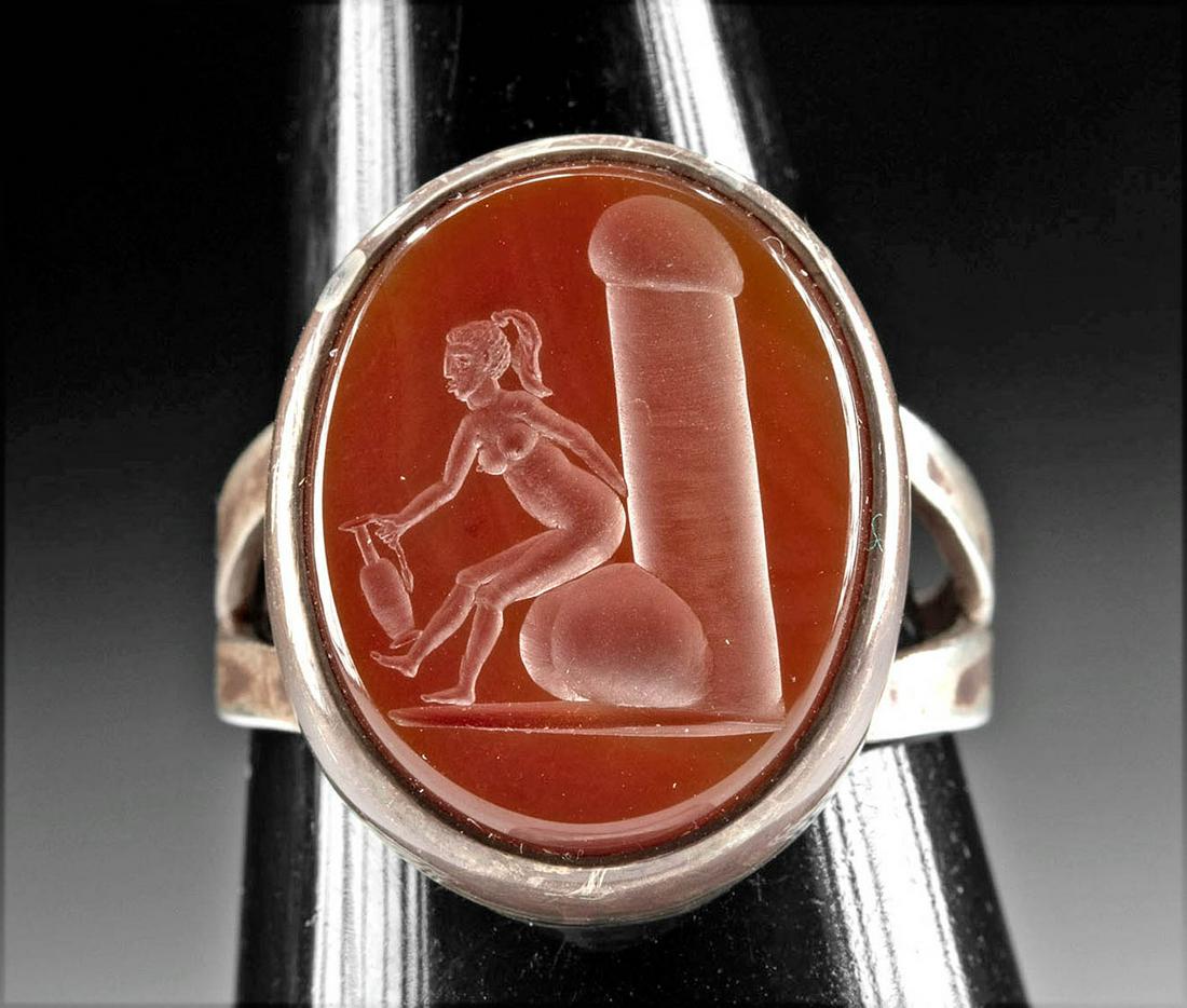 19th C. Silver Ring, Carnelian Intaglio Woman & Phallus: Western Europe, Neoclassical Period, ca. 19th century CE. A lovely carnelian intaglio, skillfully incised with an erotic scene and set in a silver ring to be wearable. Boasting a rich hue of scarlet, 