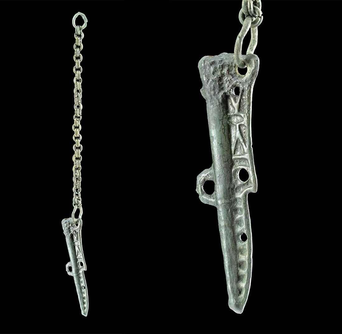 9th C. Viking Bronze Chape or Stylus Case: Northern Europe, Viking / Norse culture, ca. 9th to 12h century CE. A fine cast-bronze chape to protect the blade of a petite blade or tool, with an attached chain for suspension. The chape has a tape