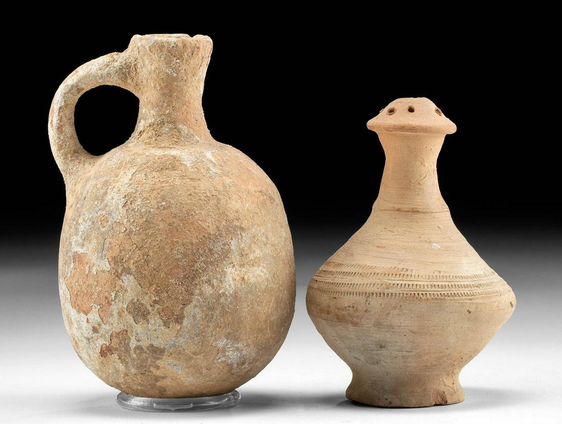 Holy Land Juglet + 12th C. Khmer Sprinkler Vessel: Near East, Holy Land, ca. 1st millennium BCE; Southeast Asia, Cambodia or Thailand, Khmer Empire (Angkor culture), ca. 12th to 13th century CE. A lovely pair of redware vessels: a juglet from the anci