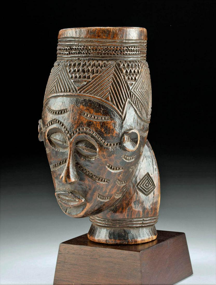 20th C. Central African Kuba Wood Portrait Cup: Central Africa, Democratic Republic of the Congo, Kuba peoples, ca. early to mid-20th century CE. A fascinating carved-wood cup in the form of a human head. Sitting upon a circular base, the curious v