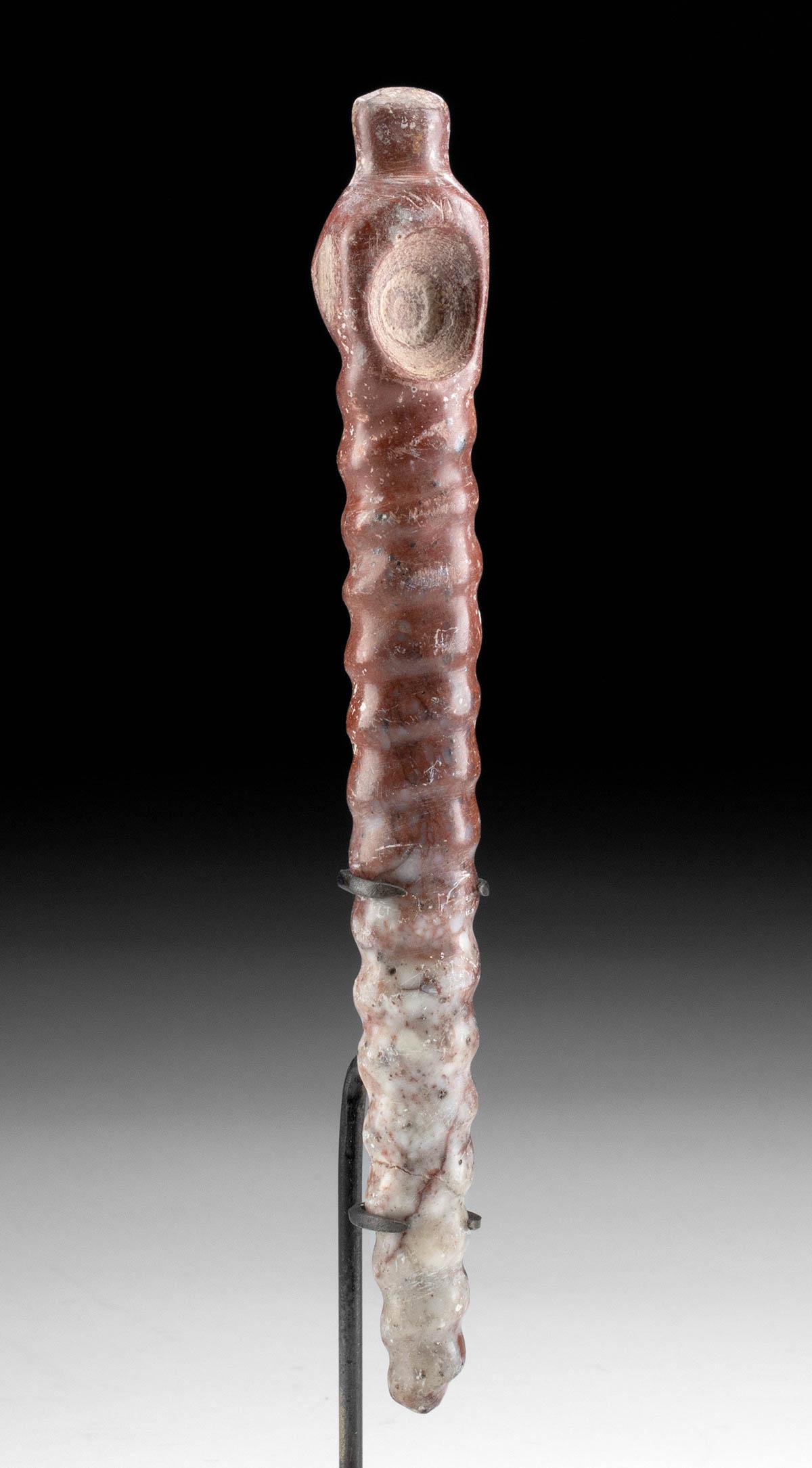 Tairona Brecciated Jasper Coca Spoon: Pre-Columbian, Colombia, Tairona culture, ca. 1000 to 1500 CE. A beautiful example of a drug implement known as a coca spoon that is hand-carved from mottled red and white brecciated jasper. The slend