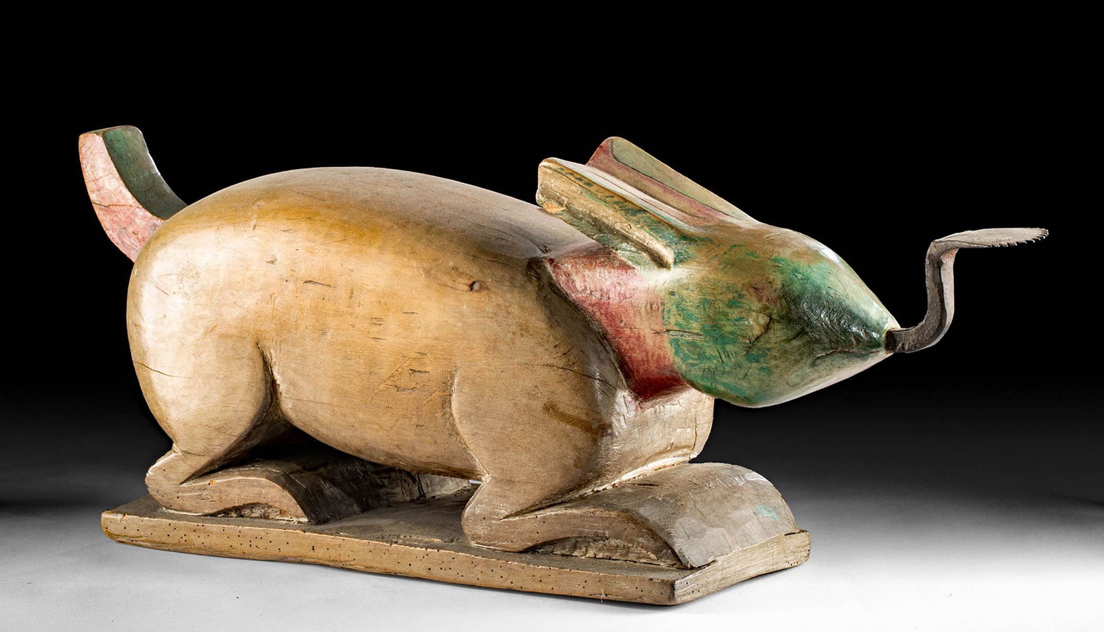 19th C. Thai Painted Wood Coconut Grater - Rabbit Form: Southeast Asia, Thailand, ca. late 19th to early 20th century CE. A handsome rabbit-shaped coconut grater carved from a large piece of wood with an iron grater projecting from the mouth. The rabbit cr