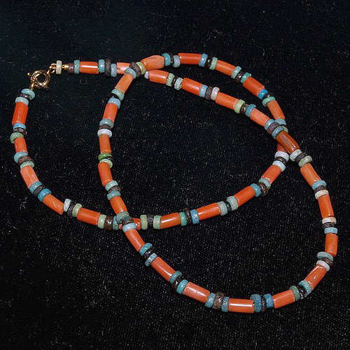 An Egyptian Coral and Faience Bead Necklace: Egypt, Late Period, ca. 664 to 332 BC. A truly lovely necklace comprising rare coral and faience bead spacers; cylindrical spherical beads are pure earthy colors the Egyptians associated with magical