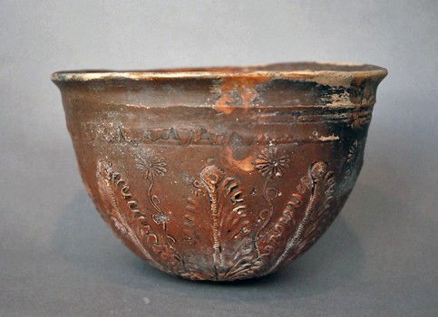 A Greek Megarian Pottery Bowl: Ancient Greek art, 3rd century B.C. Traditional bowl with a hemispherical shape, without feet and a flared lip, radiating decor with acanthus leaves and flowers delicately molded. 5-1/2"D x 3-1/2"H. P