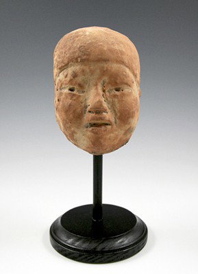 A Large Olmec Head Fragment, Pre-Classic Mexico: A large and fine head fragment from an ancient Olmec seated baby figure, from Pre-Classic Mexico circa 1000 B.C. - 500 B.C. Measuring approximately 4 1/2" tall by about 3" wide (item alone, unmounted)
