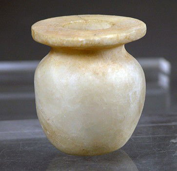 An Egyptian Late Dynastic Alabaster Jar: Egypt, Late Dynastic, ca. 652 to 300 BC. Ovoid jar with flared flat rim and thin neck. Surface shows wonderful deep deposits. 1-3/4”H. Provenance: Ex-major NYC auction house. there is NO RESERVE on