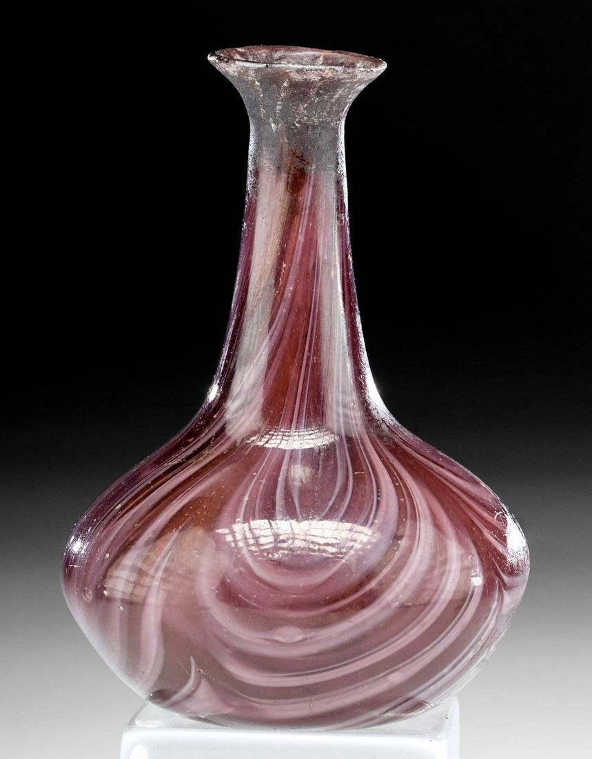 Roman Marbled Glass Flask - Aubergine & White: Roman, Imperial Period, ca. 1st to 3rd century CE. This lovely glass flask boasts beautiful mosaic patterning with aubergine and white canes, to create a marbling effect. The vessel sits on a smooth b