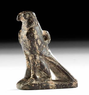 Egyptian Stone Falcon Amulet of Horus (as Falcon): **First Time At Auction** Egypt, Late Dynastic Period, 26th to 31st Dynasty, ca. 664 to 332 BCE. A petite amulet carved from chocolate-brown hardstone depicting the god Horus in the shape of a