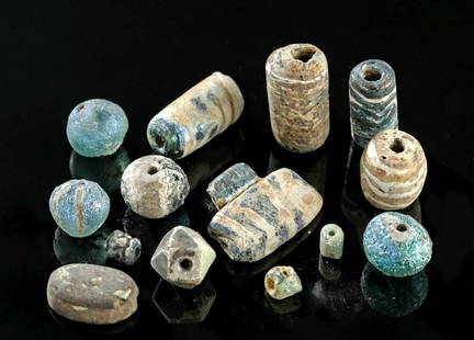 16 Highly Iridescent Greek & Roman Glass Beads: **Originally Listed At $250** Classical World, Hellenistic Greece to Roman Empire, ca. 3rd century BCE to 3rd century CE. A collection of 16 assorted glass beads, many of the millefiori style.